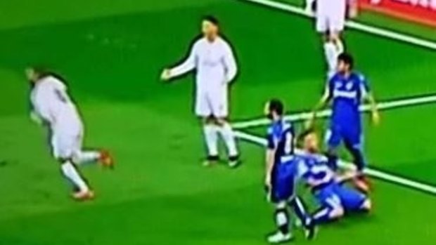 Ronaldo shrugs his shoulders as Karim Benzema celebrates.