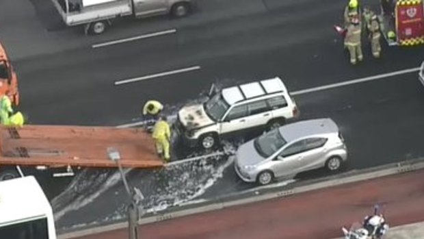 A car is removed following a fire on the Harbour Bridge on Wednesday.