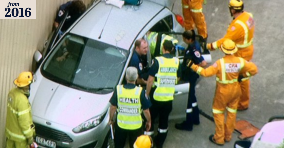 Woman flown to hospital after being pinned between car and wall in ...