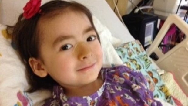 Five-year-old Julianna being treated in hospital for a neurodegenerative disease.