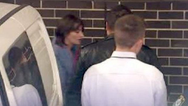 Harriet Wran is led to Liverpool Local Court.