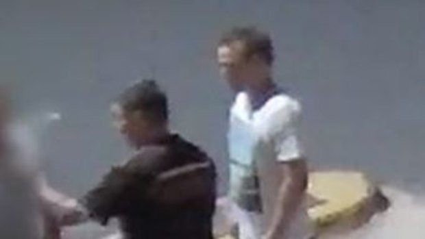 CCTV footage shows the man in the white shirt seconds before he punched the man in the dark shirt to the ground. 