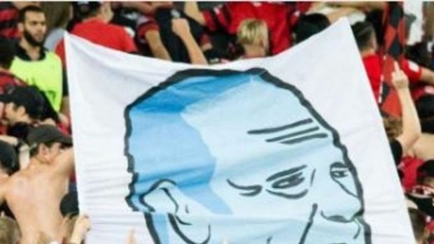 Not on: A cropped image of an offensive banner raised by wanderers fans showing Sydney FC coach Graham Arnold performing a sex act.