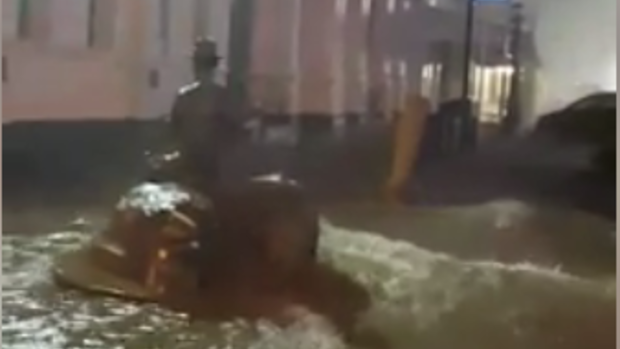 Flood waters wash over the iconic statue of Paddy Hannan in Kalgoorlie's Hannan street on Friday night. 