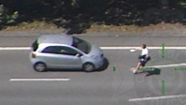 A man holding a dog in one arm and a knife in the other tried to steal this car on the Gold Coast Highway, police allege.