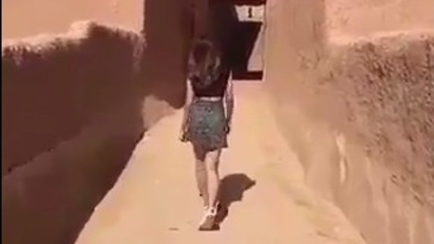 A still from the video showing  "Khulood", dressed in a skirt and t-shirt. 