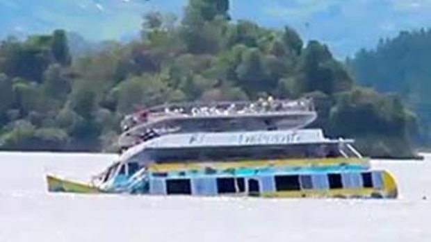 The El Almirante ferry sinks below the surface of the Guatape reservoir.