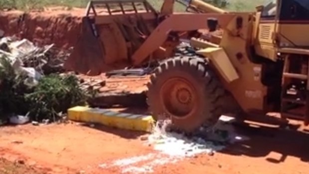Kimberley police crush slabs of confiscated beer.