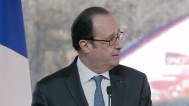 President Francois Hollande looks away after the shots are fired.