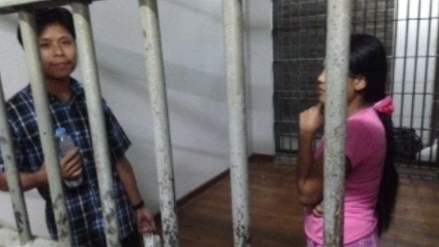 Burmese prawn shed worker Tin Nyo Win, left, and his wife, Mi San, stand in a jail cell after they were arrested in Samut Sakhon, Thailand. 