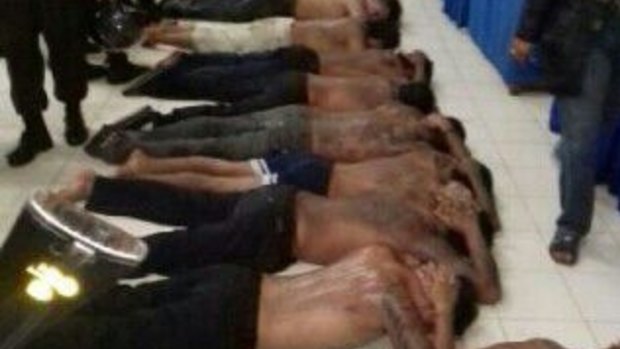 People arrested from the rival gangs lie on a floor at Denpasar Police Station on Thursday night following the violence.