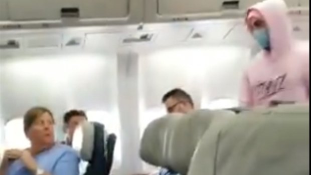 James Potok is escorted from the plane in a video posted on Twitter by a fellow passenger.