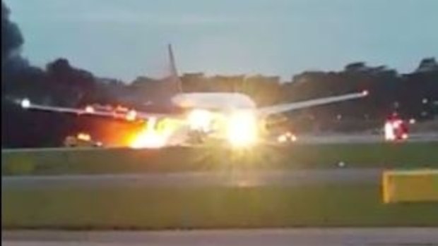The right wing of the plane erupted in flames after it landed at Changi Airport.