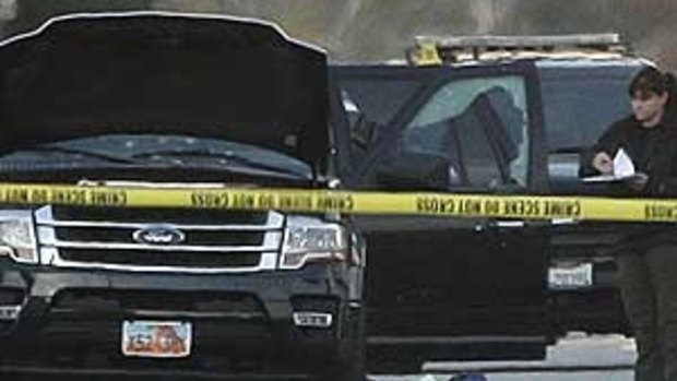 The SUV driven by shooters Tashfeen Malik, 27, and her husband, Syed Rizwan Farook, 28 in San Bernardino is examined by a policeman.