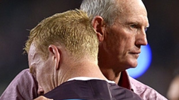 Coach Wayne Bennett consoles Bronco Jack Reed after the grand final loss.