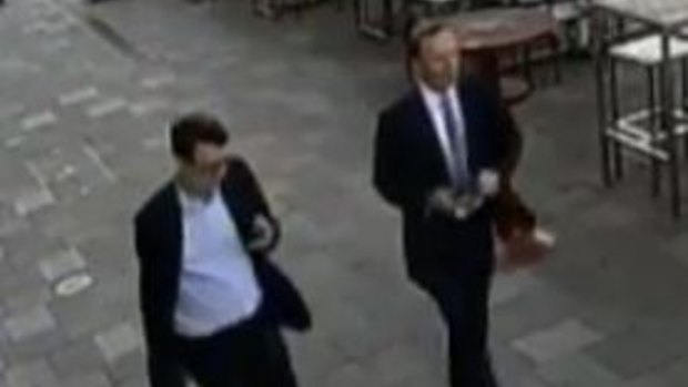CCTV shows Tony Abbott, right, and one of his staffers walking in Hobart just before the alleged assault.