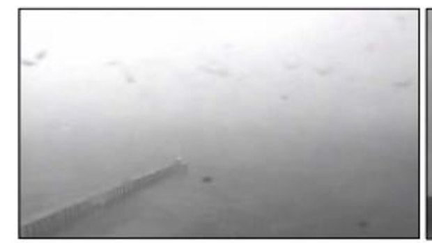A CCTV image from Port of Melbourne cameras facing east across the water from Point Lonsdale show the weather conditions. 