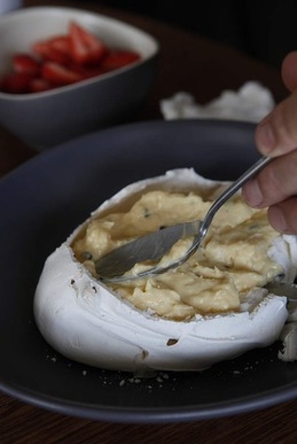 11. Spoon the custard into the pavlova and smooth