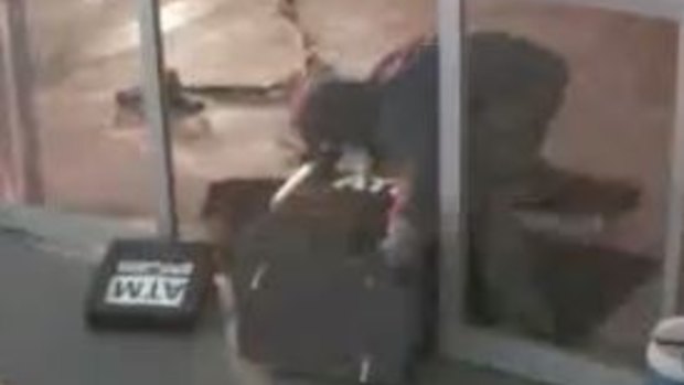 A screengrab from CCTV footage showing two men who stole an ATM from a Fyshwick petrol station.