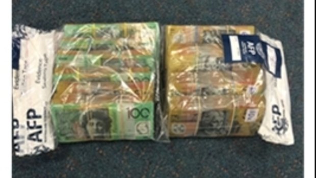 Wads of cash were seized during two drug raids in Canberra on Thursday.