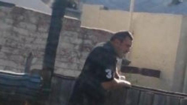 The burly man who was seen peering and jumping over fences in a back lane to Princes Street, North Carlton.