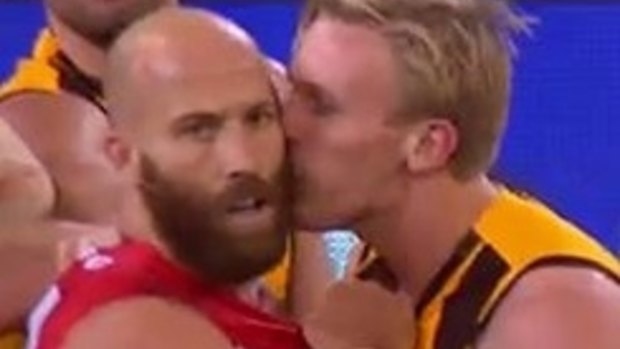 Will Langford plants a kiss on Swans vice-captain Jarrad McVeigh. 