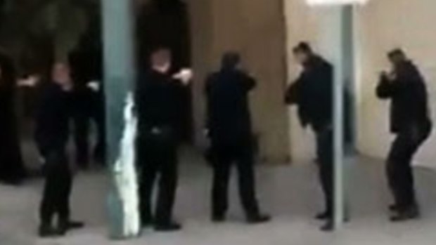 San Francisco police surround Mario Woods before fatally shooting him, seen in a video screengrab shot on a mobile phone.