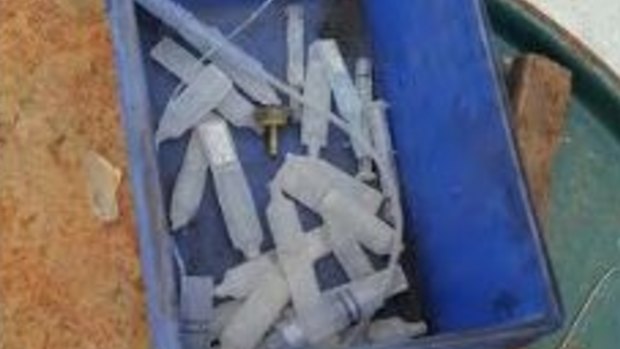 Box full of syringes and sharps, with some needles found at OI Glass at South Brisbane
