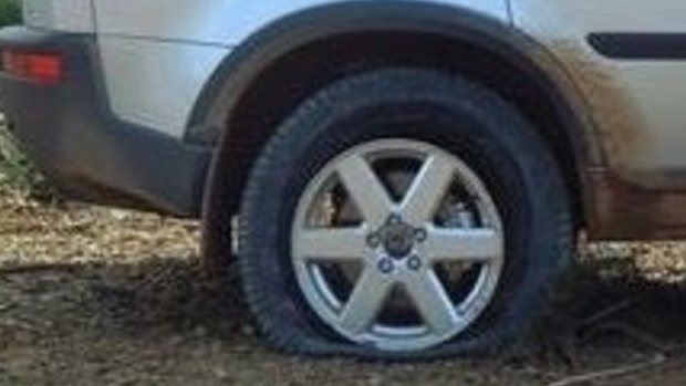 A slashed tyre on one of the vehicles damaged in the attack.