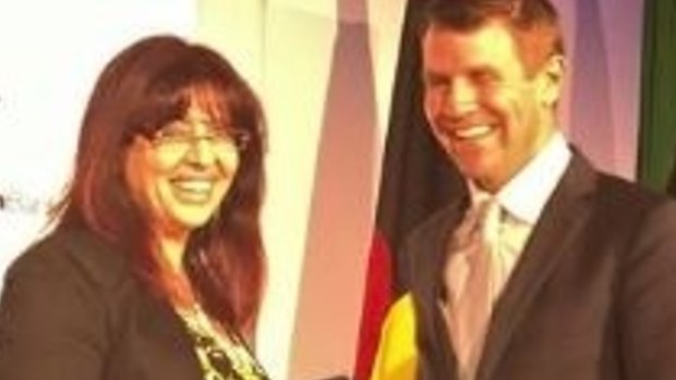 Eman Sharobeem receives her commendation in the Australian of the Year Award from then-NSW premier Mike Baird.