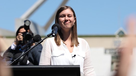 Brittany Higgins addressing thousands of people outside Parliament House, the building she was allegedly raped in.