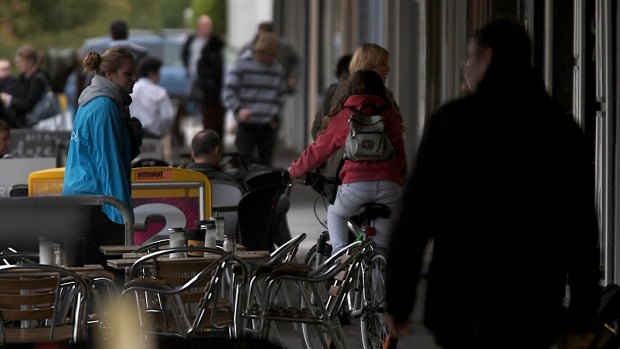 A bike rider on the footpath in Clifton Hill.