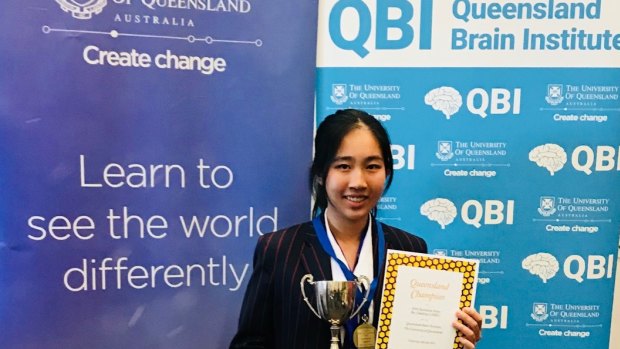 Jennifer Mai shows off her trophy as the 2018 Queensland Brain Bee champion.