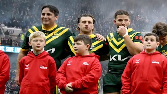 Daniel Jarvis links arms with Munster during the Australian national anthem.
