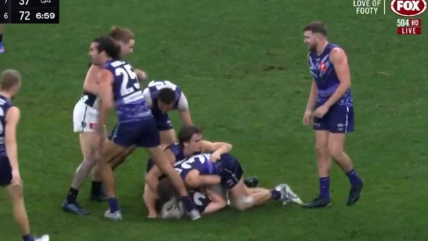 Sam Switkowski was suspended for two weeks for this ‘chicken wing’ tackle on Jack Ginnivan. Photo: Fox Footy