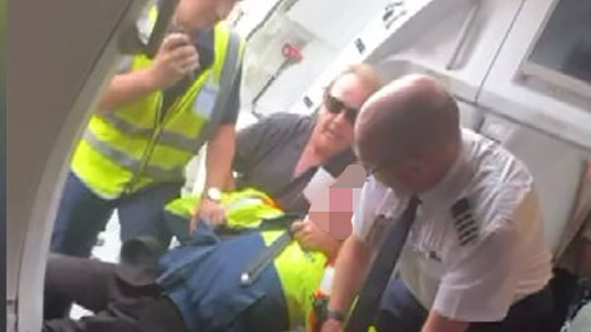 Footage of the teenager being restrained after attempting to board the flight with a gun.
