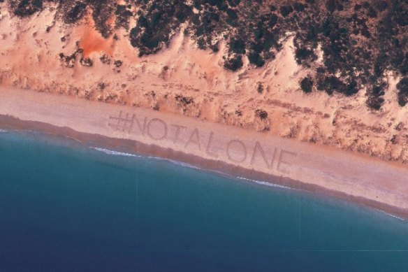 The Not Alone hashtag on Cable Beach with a photo taken via satellite.