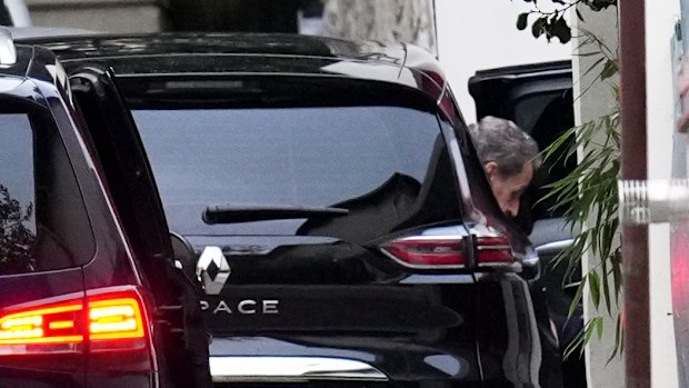 Former French President Nicolas Sarkozy arrives at his home after being released from prison on Monday.