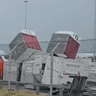 Containers flying through the air at Perth Airport on Sunday during an intense storm. 