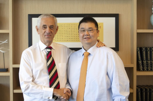 Michael Gu, right, founder of failed property group iProsperity, with Sydney solicitor John Landerer.