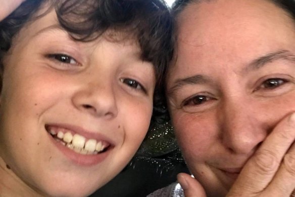 Jen Clark with her eight-year-old son Kai who spent the night in the library of his school due to floodwaters. 