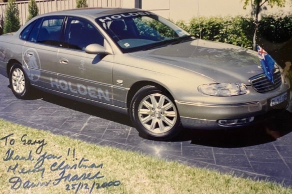 A photo of the Holden car that Gary Merlino used to chauffeur Dawn Fraser in 2000, autographed by the Olympic great. 
