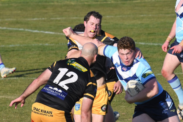 Tumut’s Michael Fenn is tackled by Derek Hay of Gundagai.