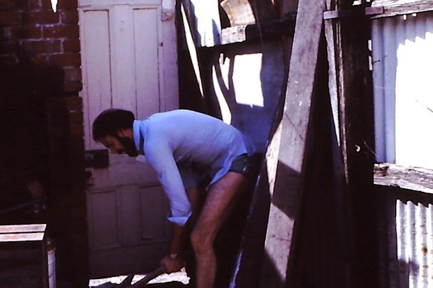 Neil Robertson fixing the outhouse at his second home in Newry Street, Fitzroy North. 