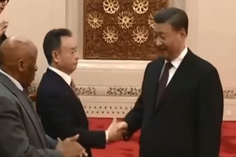 Businessman Chau Chak Wing shakes hands with Chinese President Xi Jinping during a meeting of global leaders in Beijing.