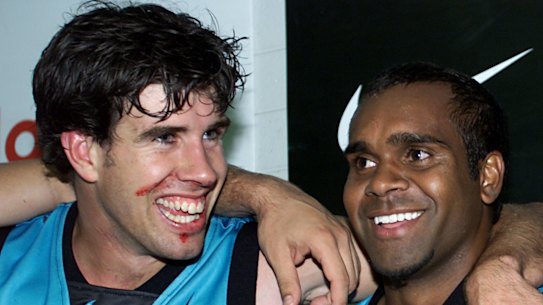 Stuart Cochrane (left) sings the song with Byron Pickett after a Port Adelaide win.