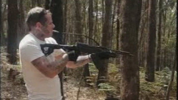 Matthew Bruce firing a semi-automatic weapon.