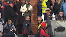 Damien Hardwick chats back to a fan after comments come his way through the crowd.