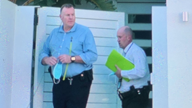 Queensland detectives leave a Palm Beach house owned by Mick Doohan, where Peter Fox has been staying.