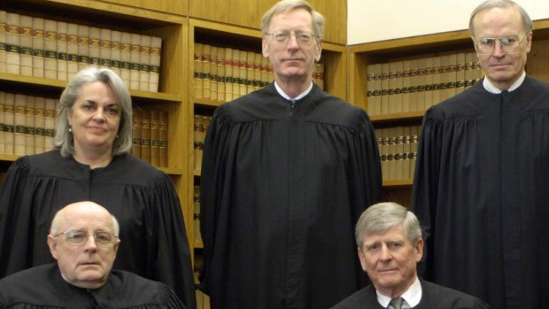 Top shelf: Crennan's mother, Susan Crennan QC when she was a High Court judge. To her right is Commissioner Kenneth Hayne during his High Court days. 